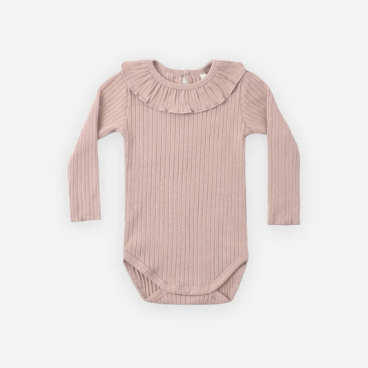 A long-sleeve baby bodysuit in a dusty rose pink ribbed knit fabric, featuring a ruffled collar, laid flat against a light gray background.