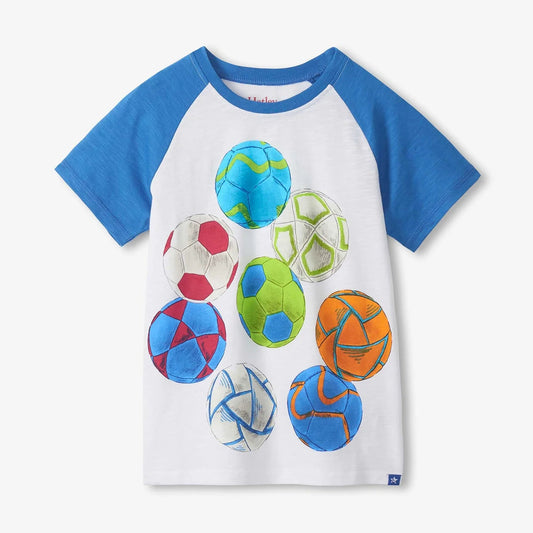 Children's t-shirt with colorful ball graphics on a white background
