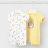 Two baby rompers, one with animal print and one yellow, hanging on a white background.