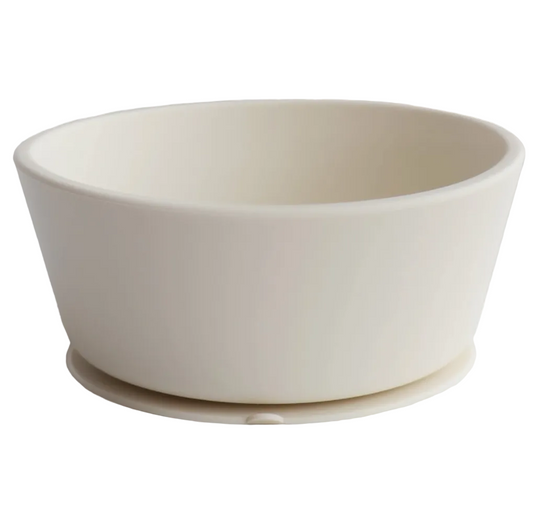 A beige silicone suction bowl with a smooth interior and a small suction base