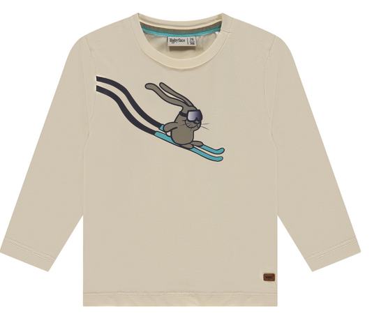 Ivory long-sleeved top with a graphic of a bunny on skis in the center, round neckline, and a small brand tag on the lower left side.