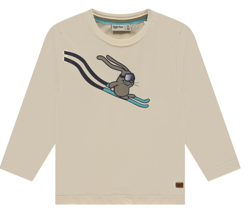 Ivory long-sleeved top with a graphic of a bunny on skis in the center, round neckline, and a small brand tag on the lower left side.