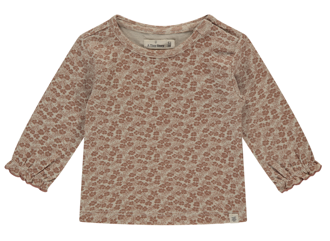 Long-sleeved dusty rose top with a floral pattern and a round neckline.