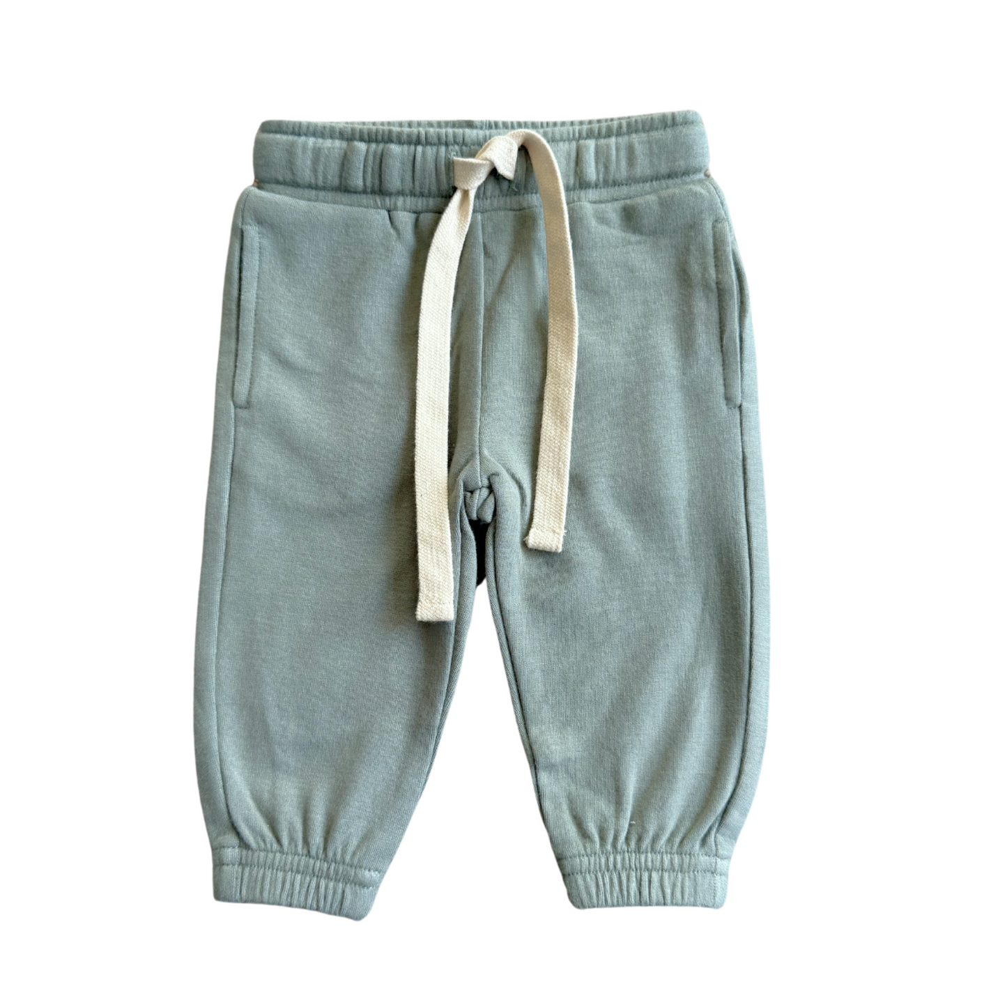Light blue sweatpants with a drawstring on a white background