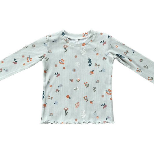 White long-sleeve shirt with floral pattern on a white background