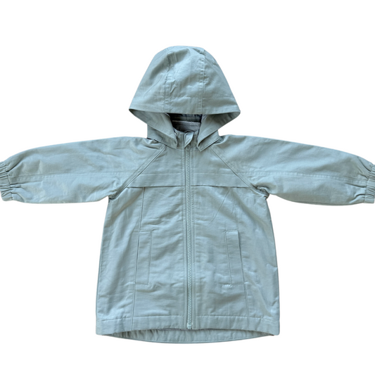 Light aqua children's raincoat with a hood on a white background