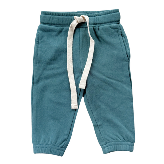 Blue children's sweatpants with a white drawstring on a white background