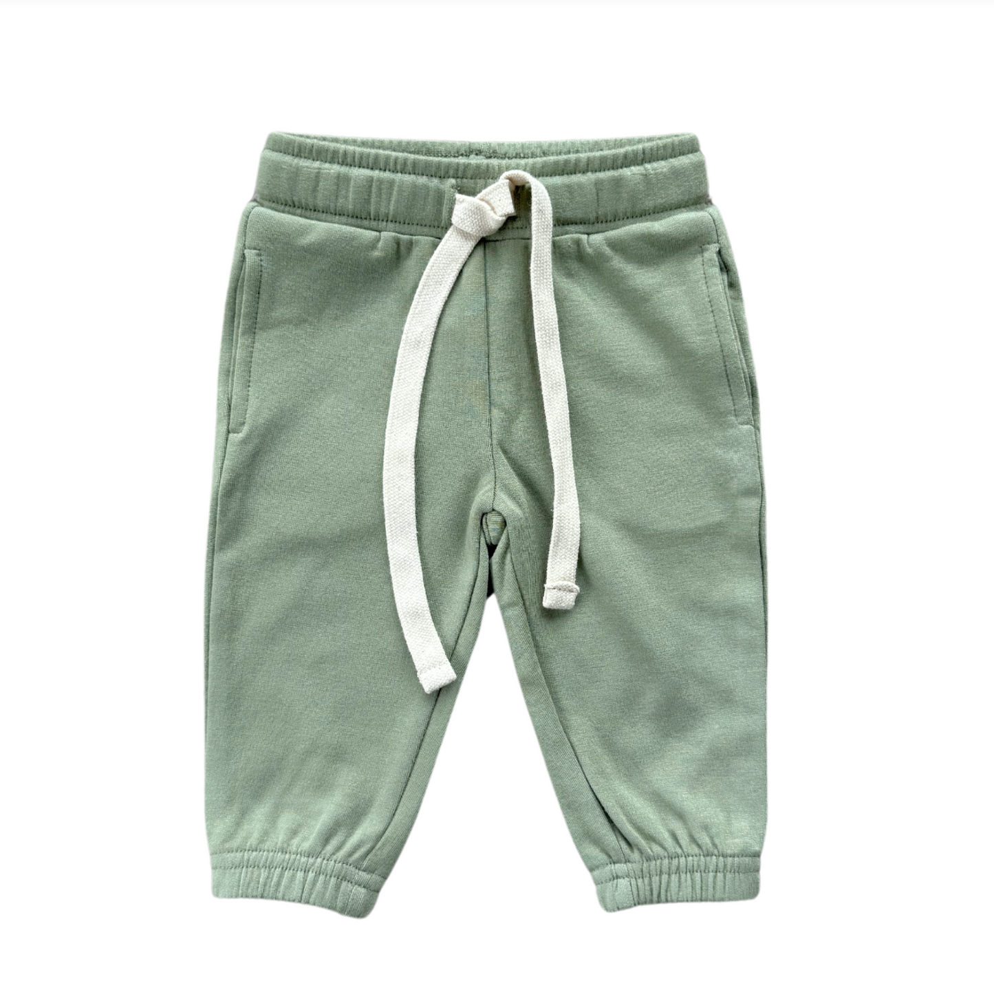 Green children's sweatpants with a white drawstring on a white background