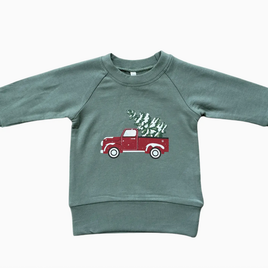 Green sweatshirt with a red truck graphic on a white background