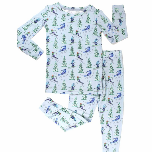 Children's pajama set with bird and nature pattern on a white background
