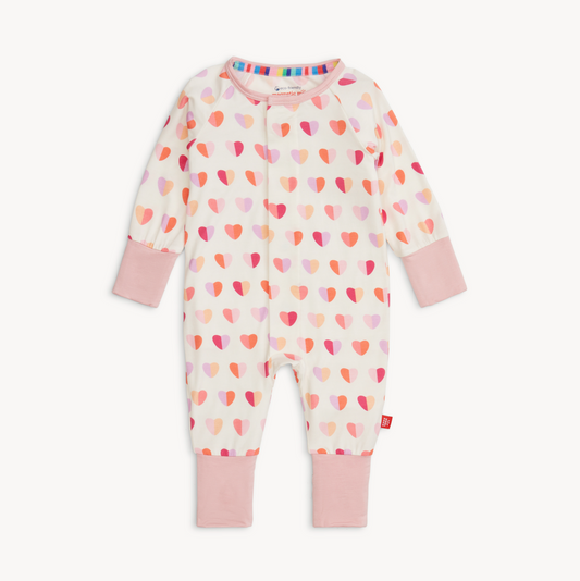 Baby onesie with heart pattern and pink accents on a white background