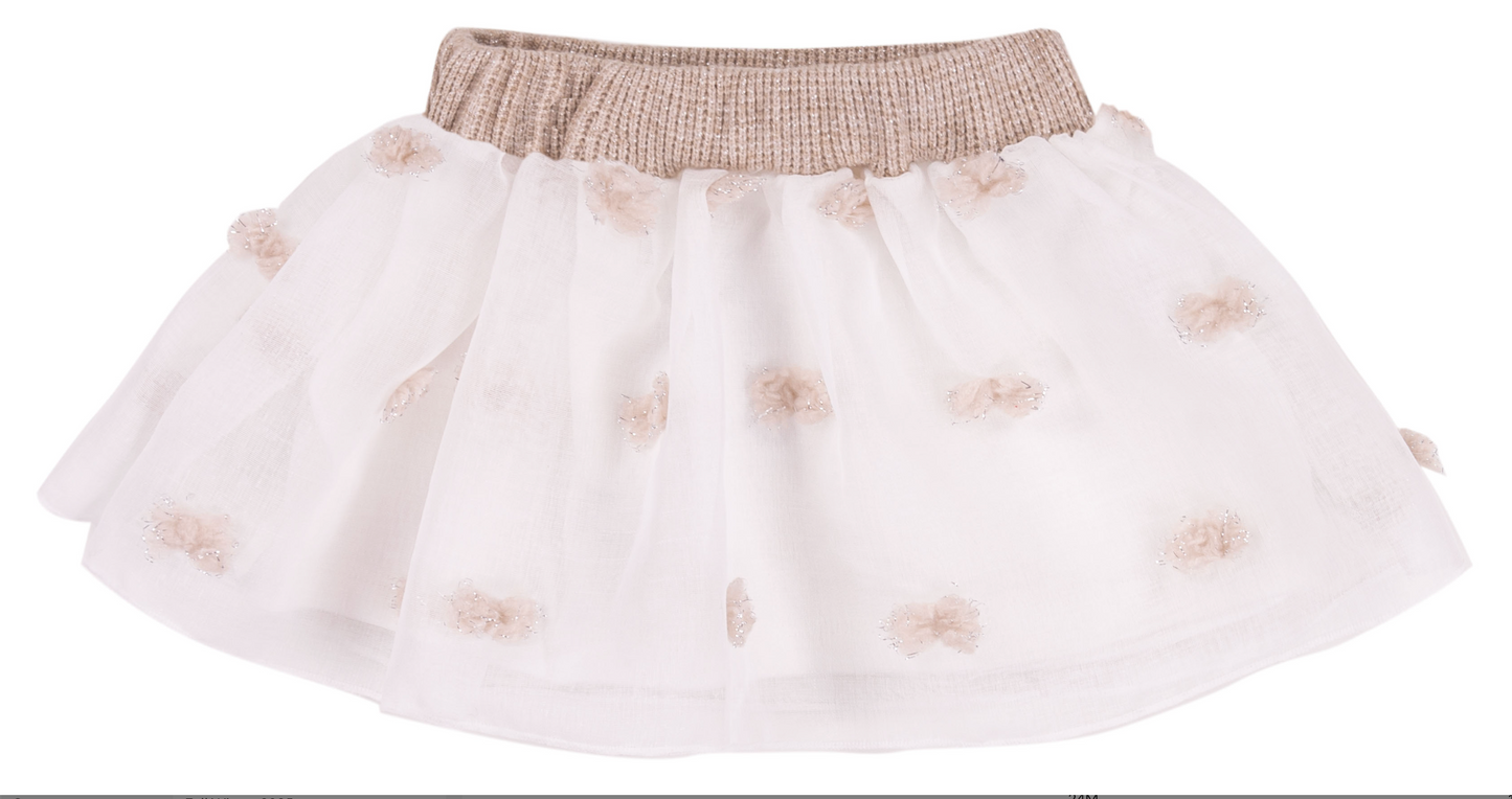White skirt with gold embellishments on a white background