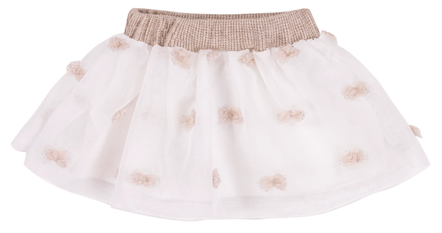 White skirt with gold embellishments on a white background