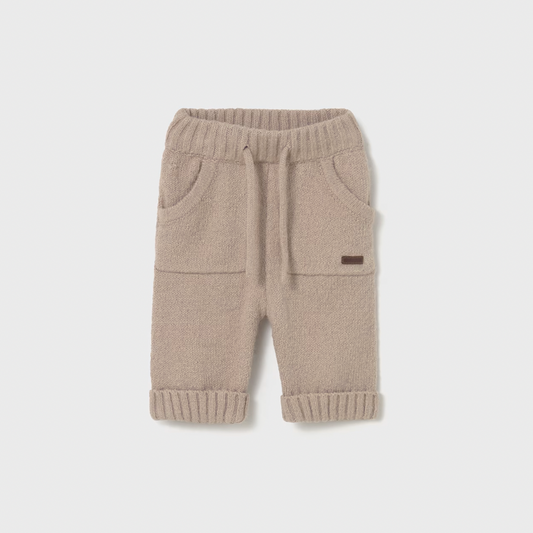 Beige baby pants with a small logo on a light gray background