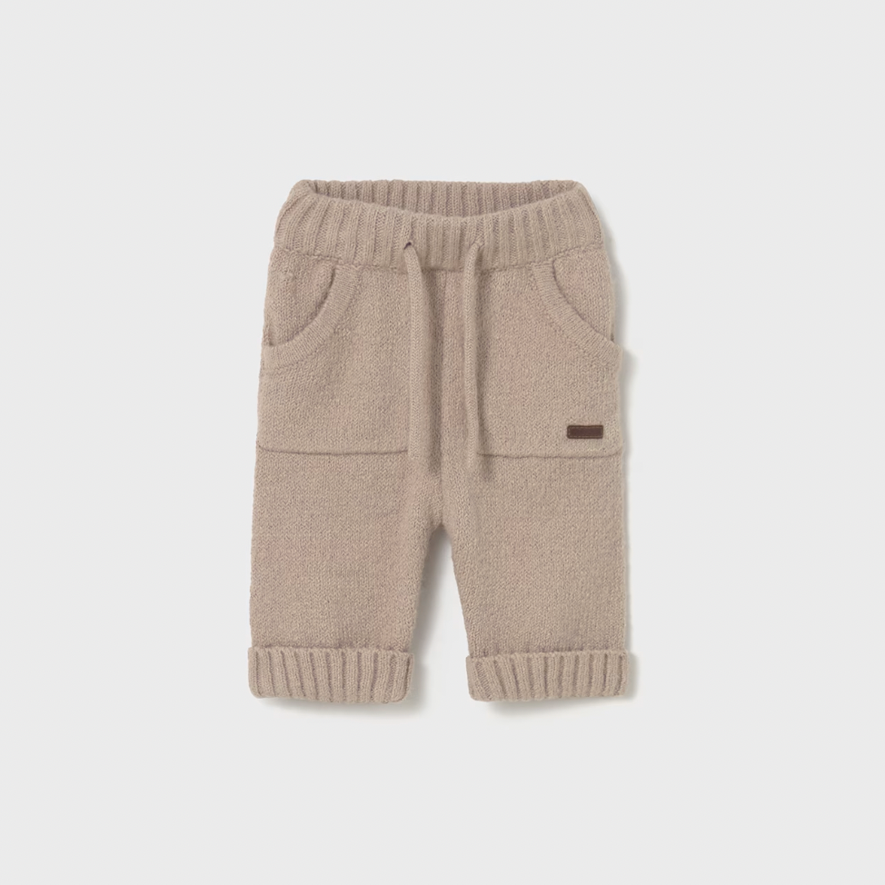 Beige baby pants with a small logo on a light gray background