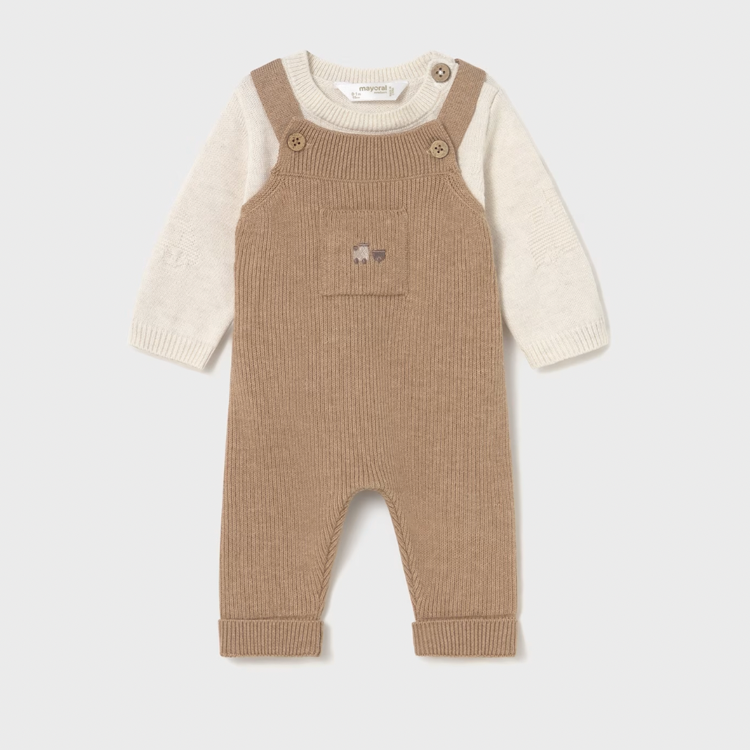 Brown ribbed baby overalls with a white shirt underneath on a light gray background