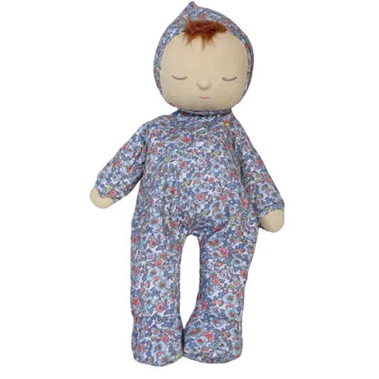 Stuffed doll with floral patterned outfit on a gray background