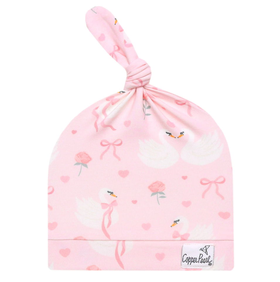 Pink baby hat with flamingo design and 'Copper Pearl' branding on a white background