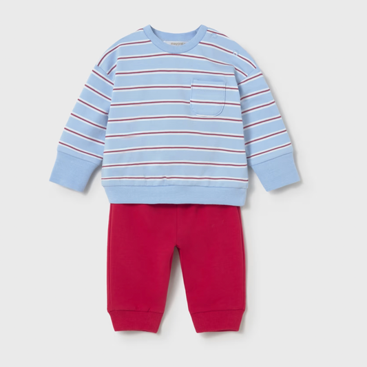 Children's outfit with a blue and red striped sweatshirt and red pants on a light gray background