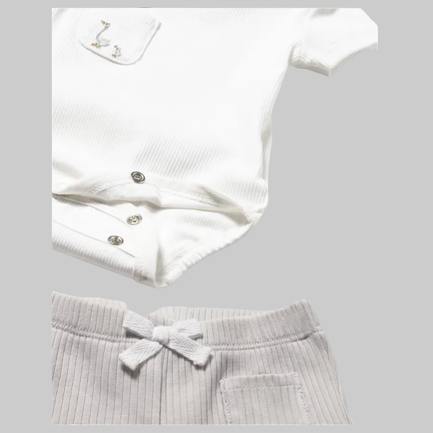 White ribbed onesie and shorts on a light gray background
