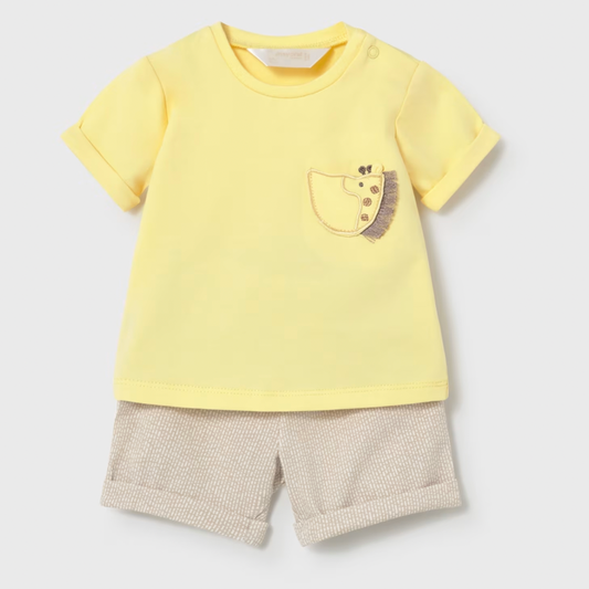 Yellow t-shirt with a giraffe design and beige shorts