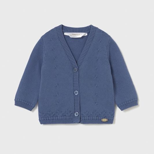 Blue knitted cardigan on a light gray background