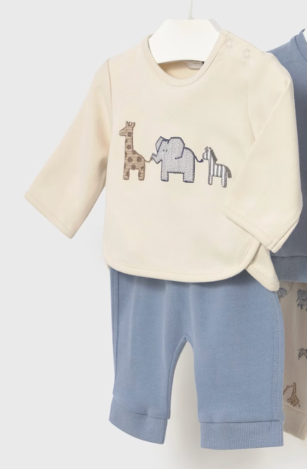 Baby outfit with cream top and blue pants featuring animal designs on a white background