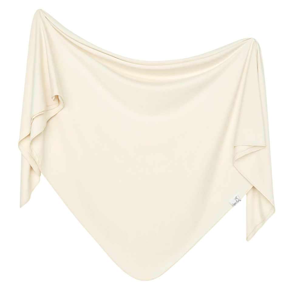 Beige fabric draped over a white background