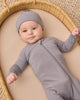 Baby wearing the Slate Bamboo Zip Footie by Quincy Mae