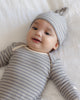 Baby wearing the Slate Microstripe Gown + Hat, lifestyle photo