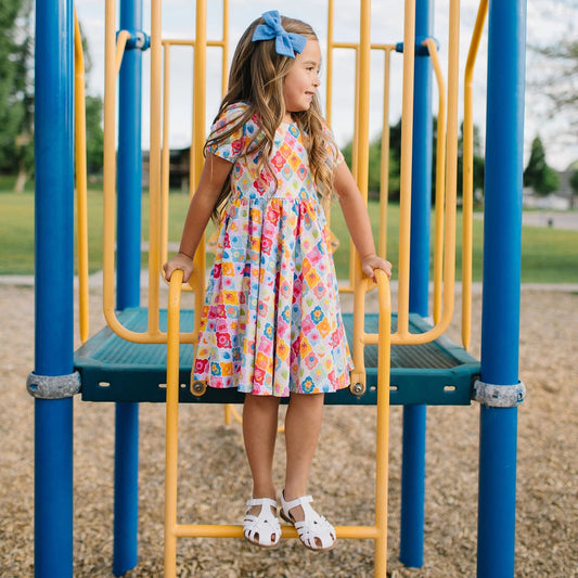 Girl in multi colored flower twirl dress