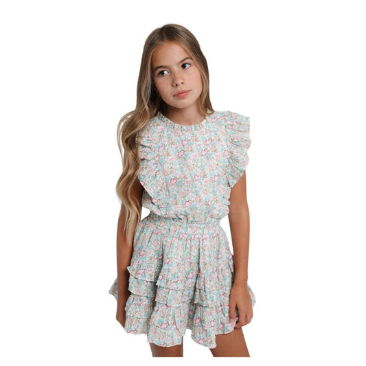Young girl wearing a floral dress on a white background