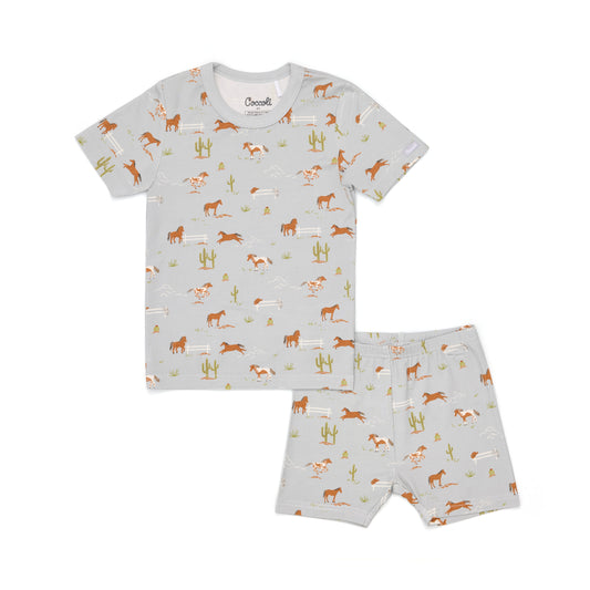 Children's pajama set with horse pattern on a light gray background