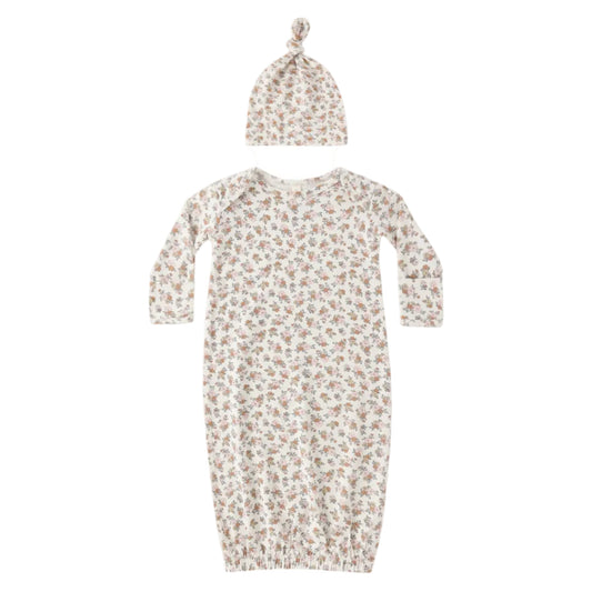 Baby gown with floral pattern and matching hat on a white background