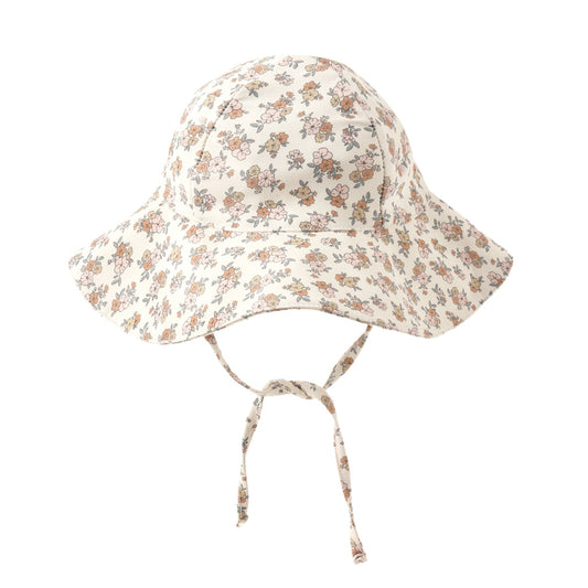 Floral patterned baby hat with chin tie.