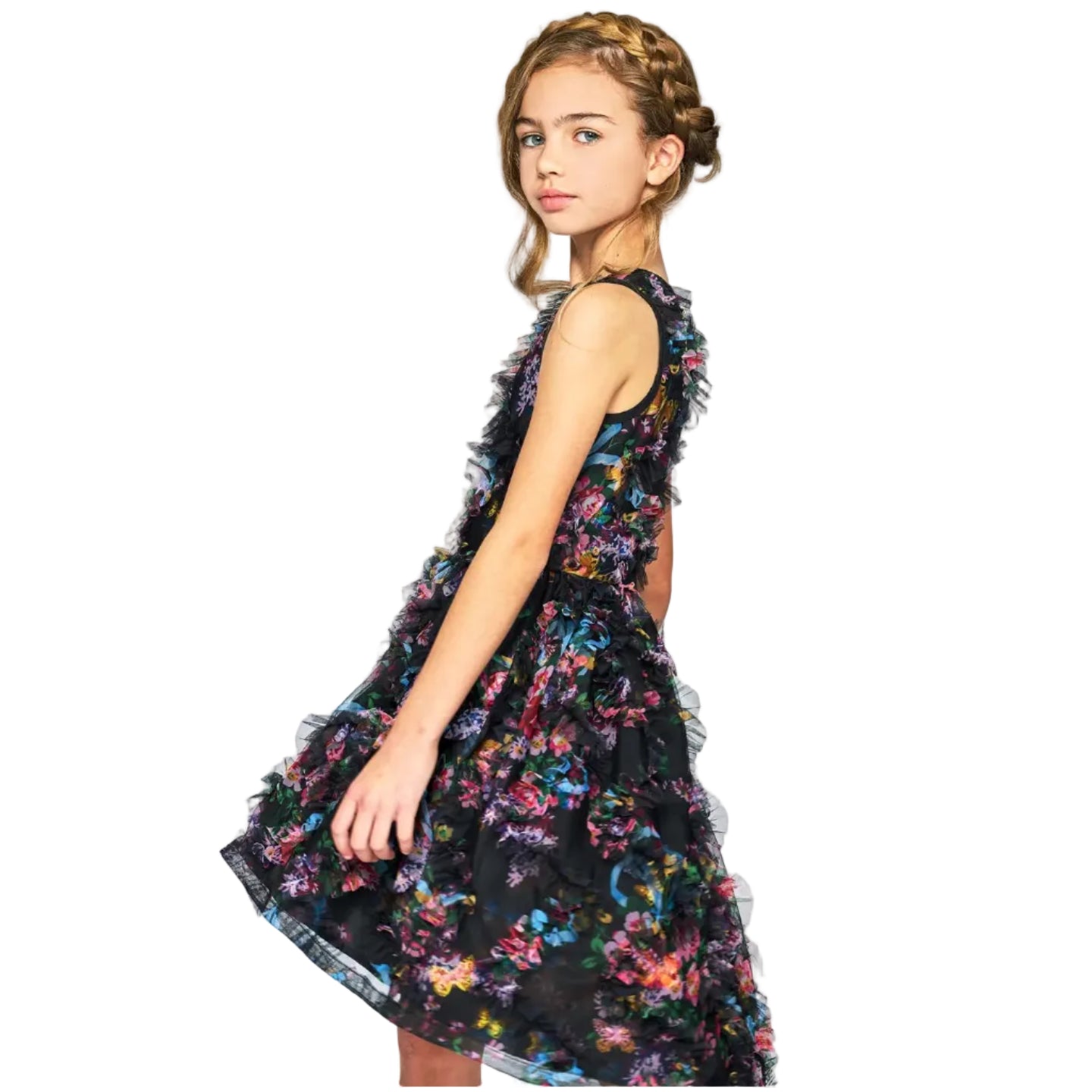 Young girl wearing a floral dress on a plain background