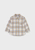 Plaid shirt with beige, blue, and white pattern on a light gray background