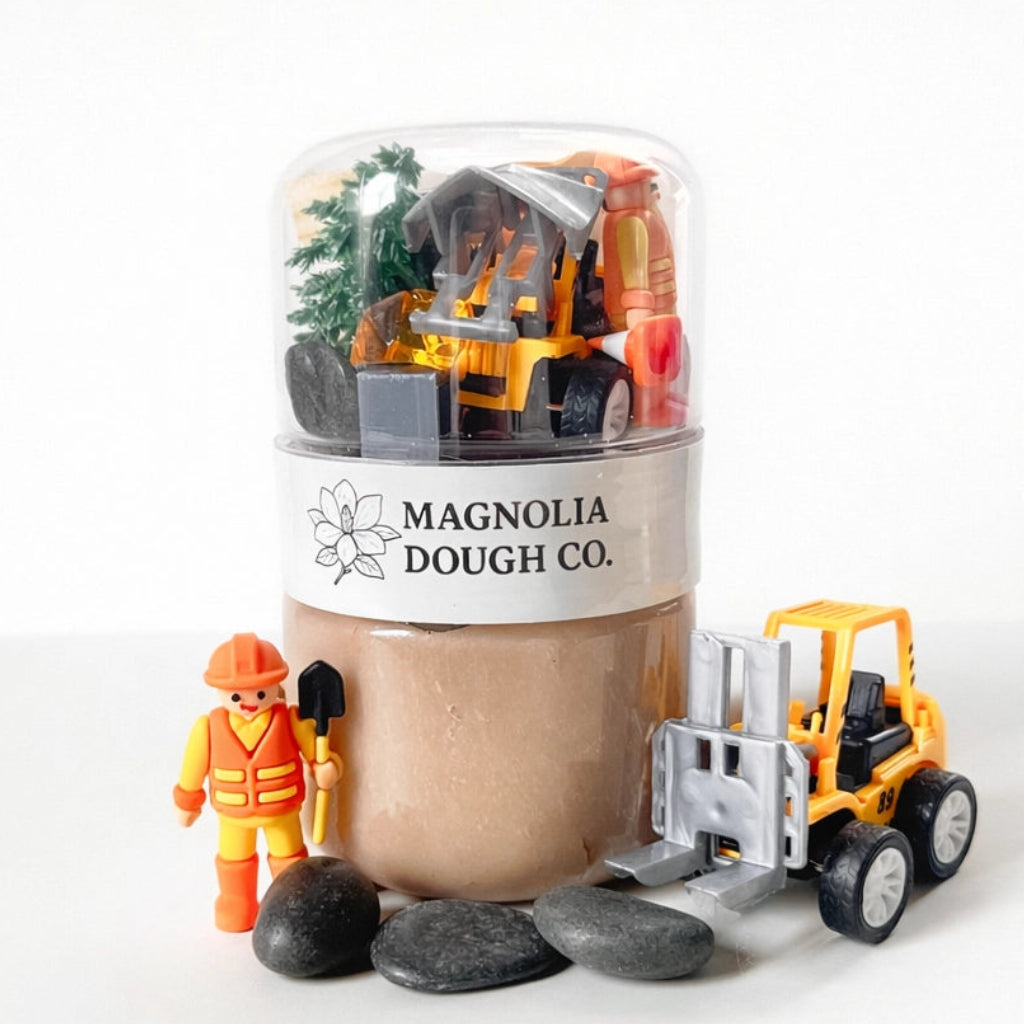 Toy construction set with a container labeled 'Magnolia Dough Co.' on a white background