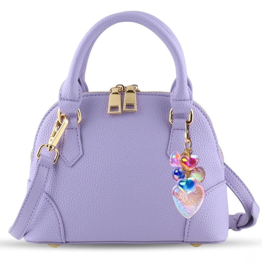Lavender handbag with gold accents and a colorful heart charm on a white background