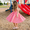Girl in Pink and Red pattern twirl dress