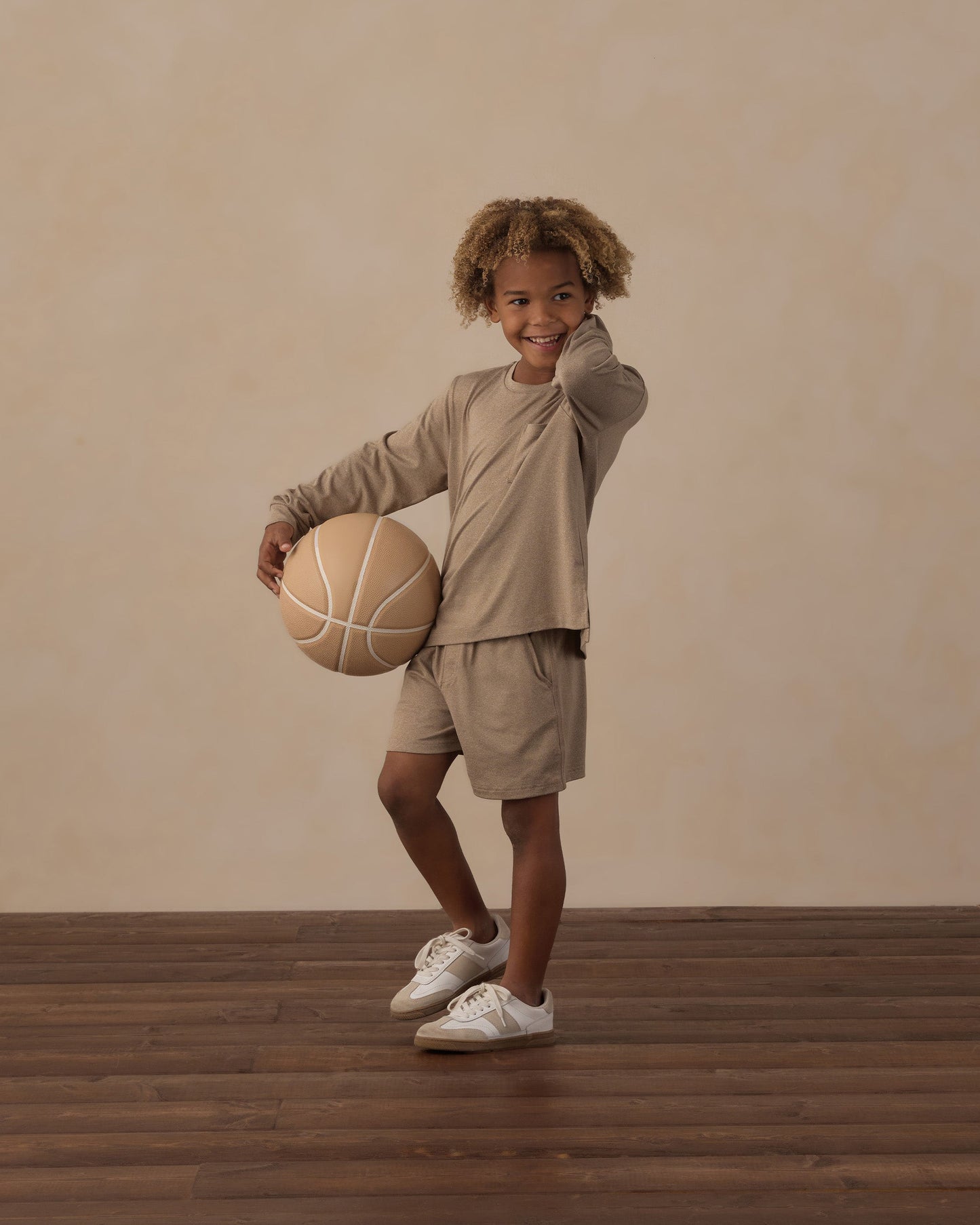 Child playing outdoors in the Heather Olive Pocket Tee