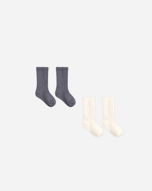 Baby wearing Quincy Mae Ivory and Midnight socks set