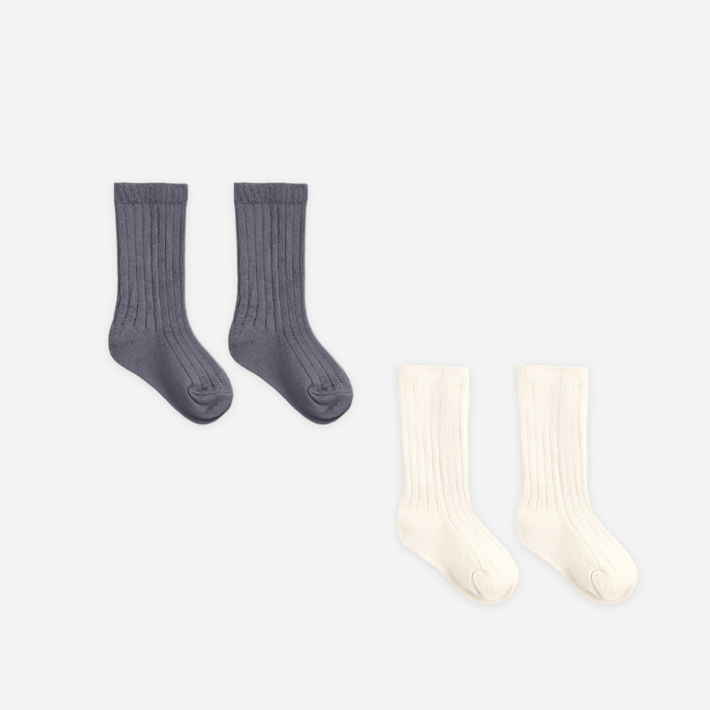 Baby wearing Quincy Mae Ivory and Midnight socks set