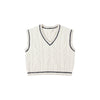 White cable knit vest with black trim on a white background
