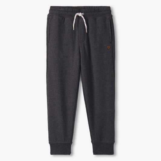 Dark gray sweatpants with a small red heart on a white background