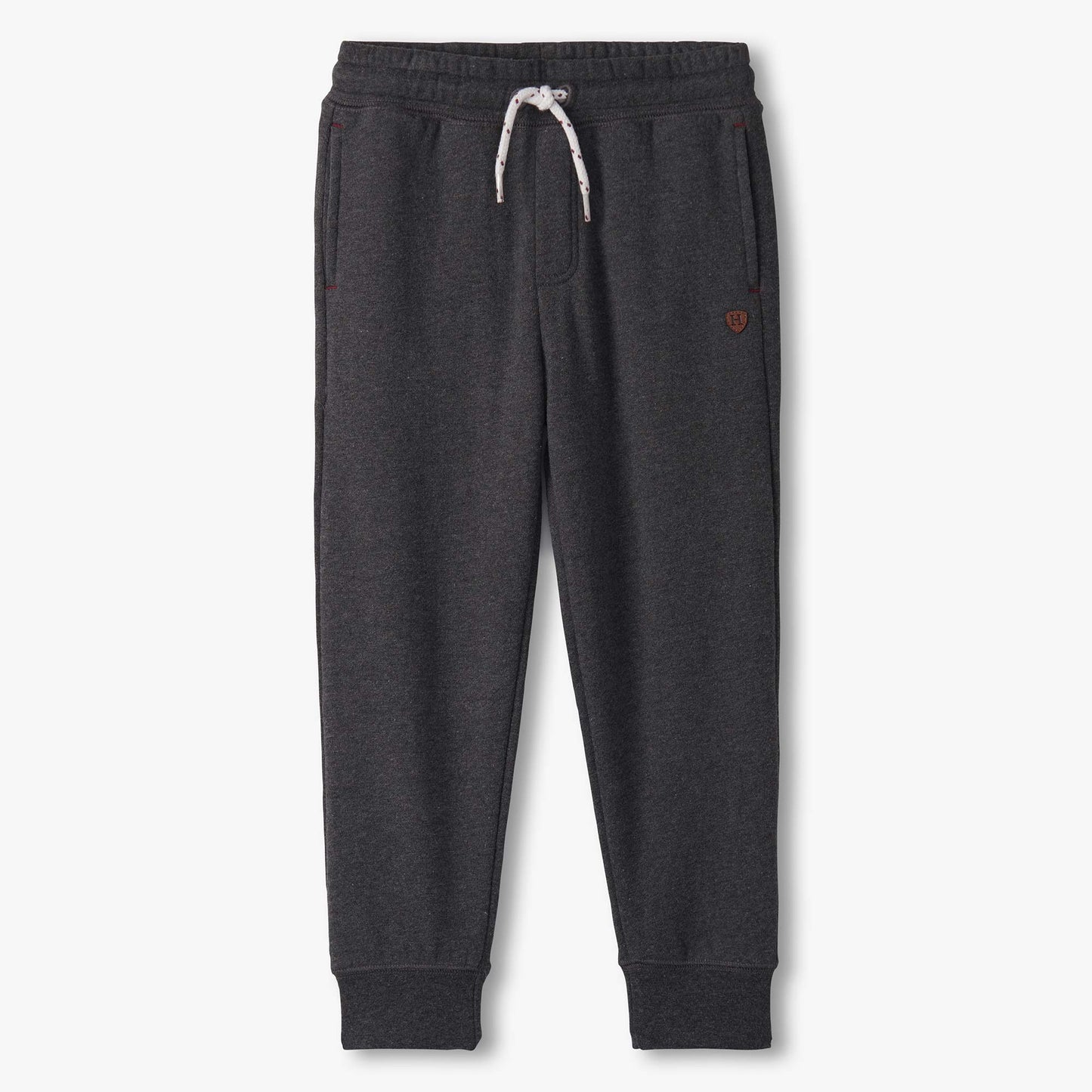 Dark gray sweatpants with a small red heart on a white background