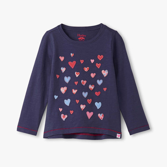 Navy long-sleeve shirt with colorful heart pattern on a light gray background