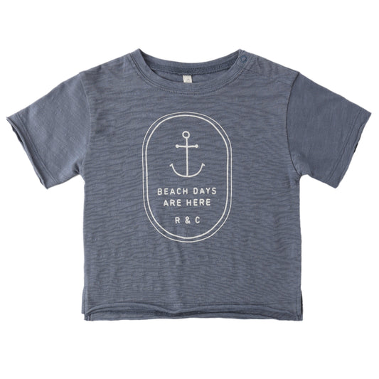 Blue t-shirt with anchor design and text on a white background
