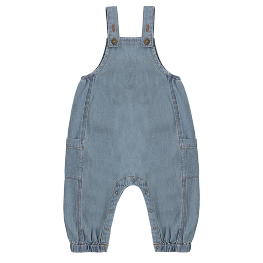 Blue denim overalls on a white background