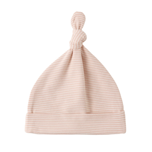 Pink ribbed baby hat on a white background